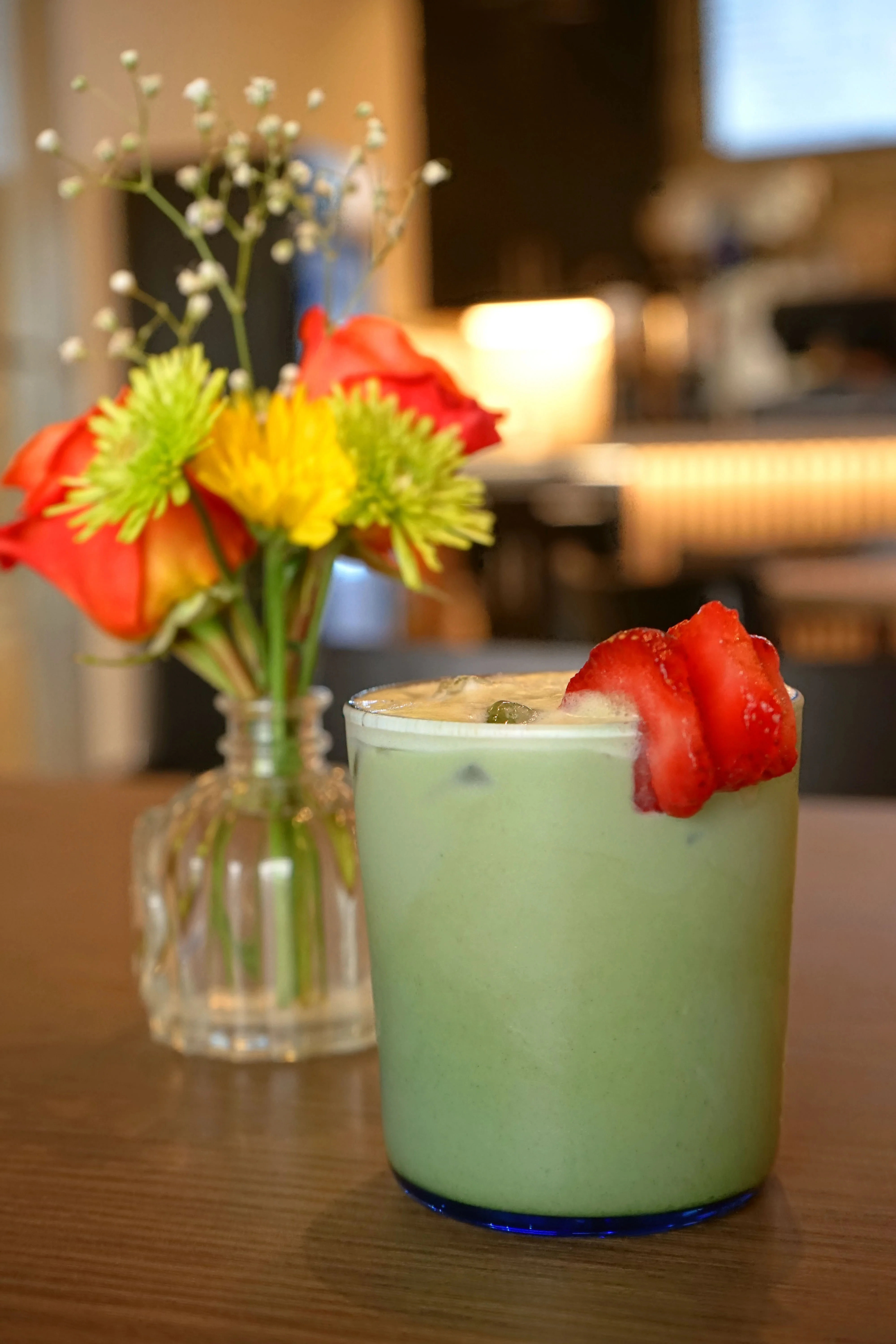 Matcha latte with strawberries in a cozy café setting