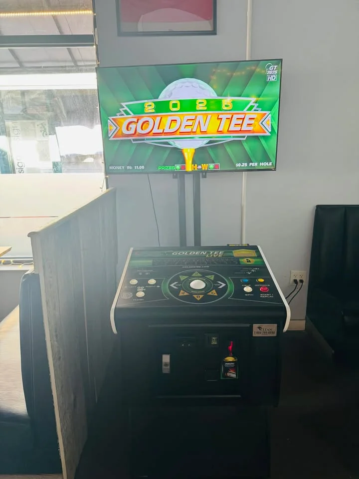 Golden Tee 2025 arcade game machine in a restaurant setting