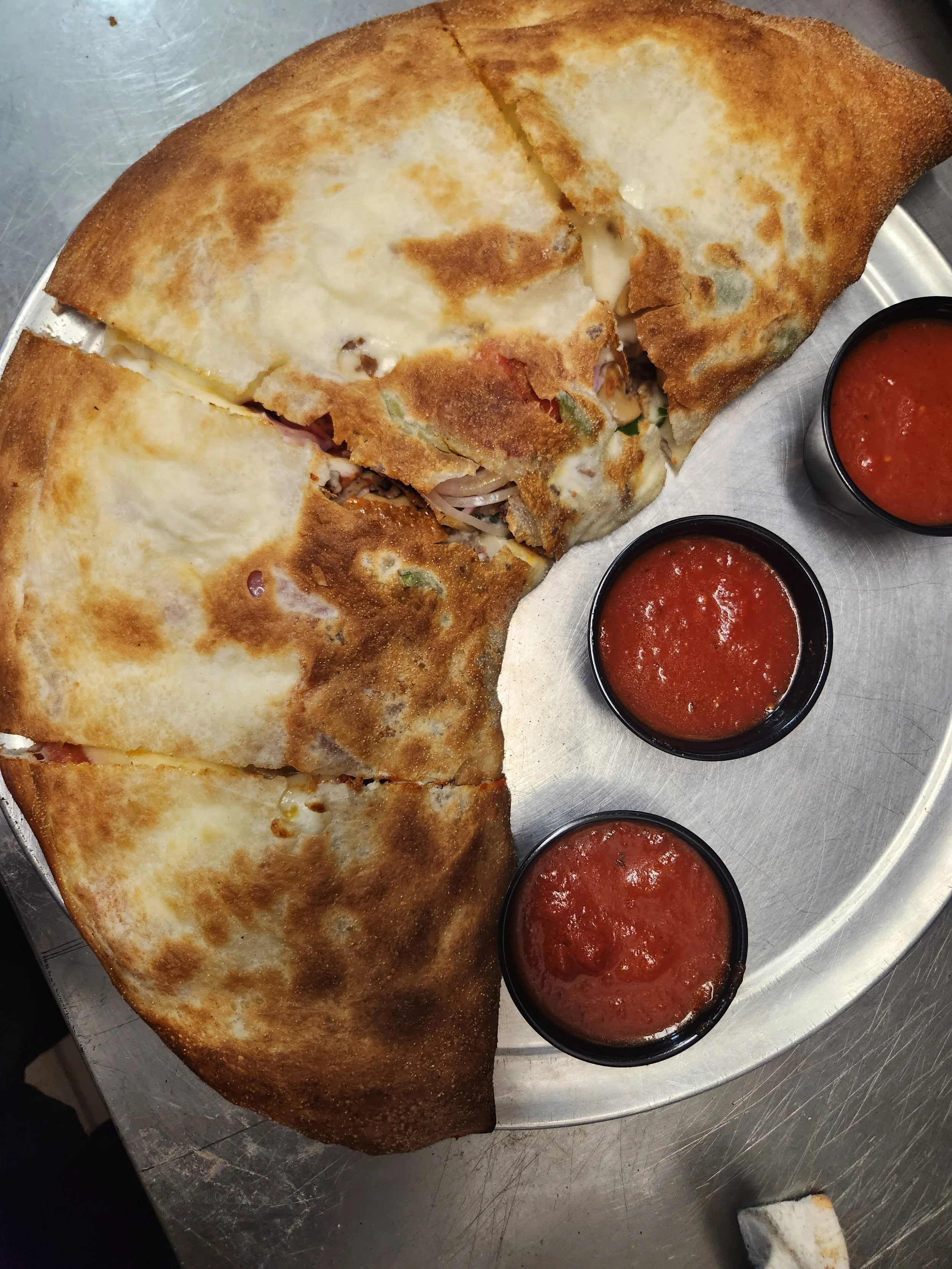 Delicious calzone served with marinara sauce