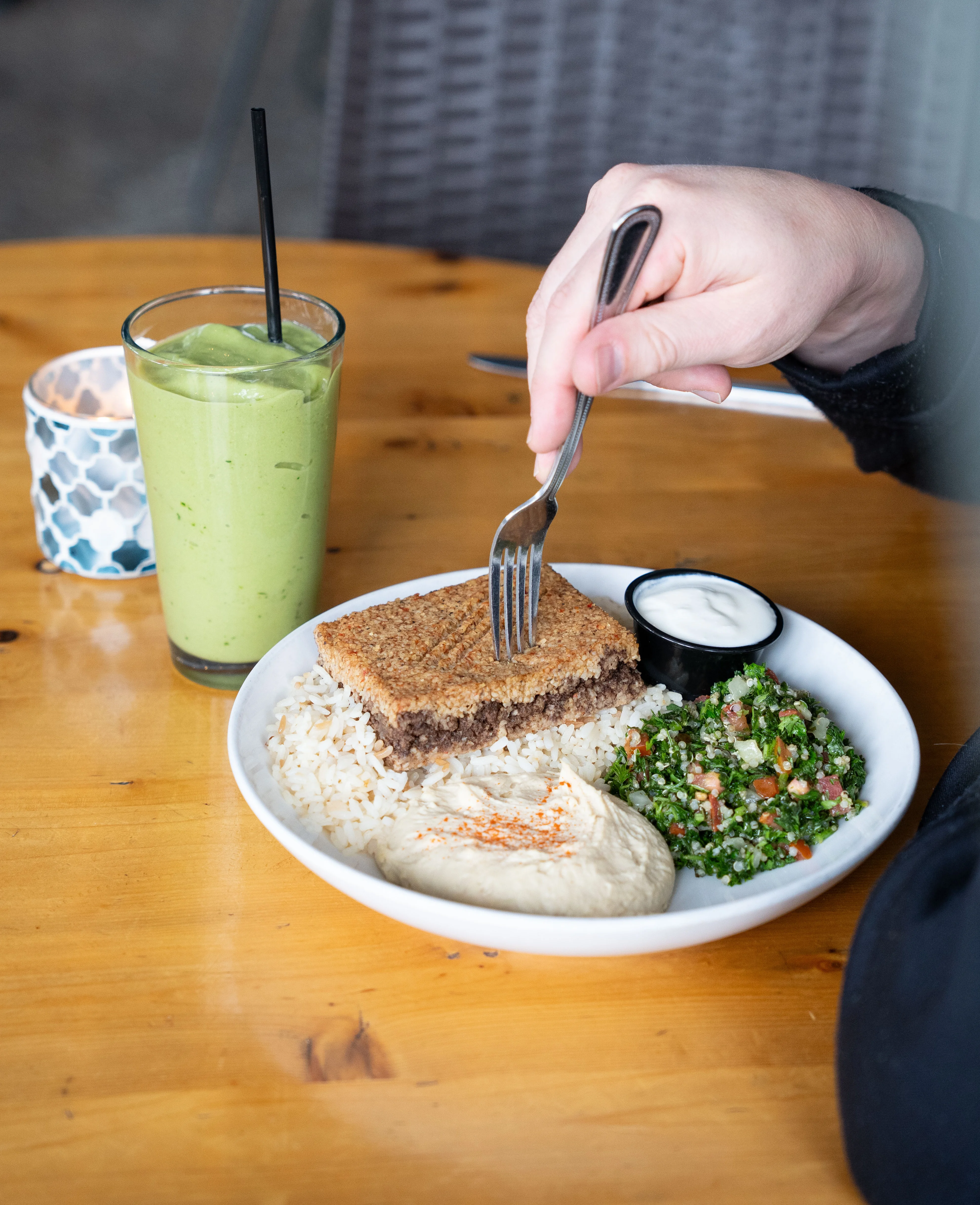 Middle Eastern kibbeh served with rice and tabbouleh salad