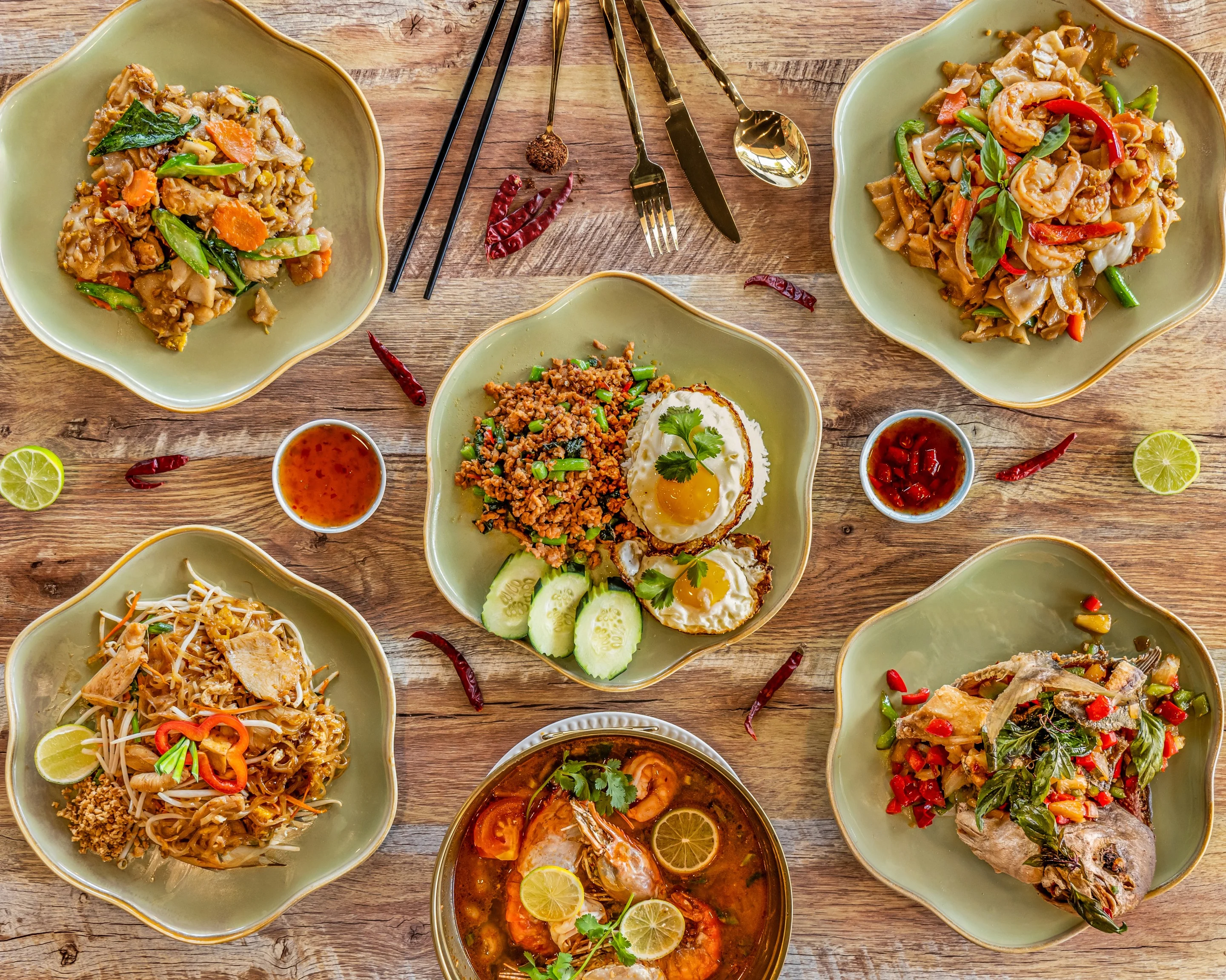 Assorted Thai dishes including pad thai and tom yum soup