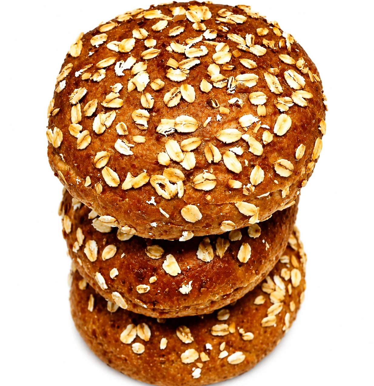 Three stacked oat cookies topped with sesame seeds.
