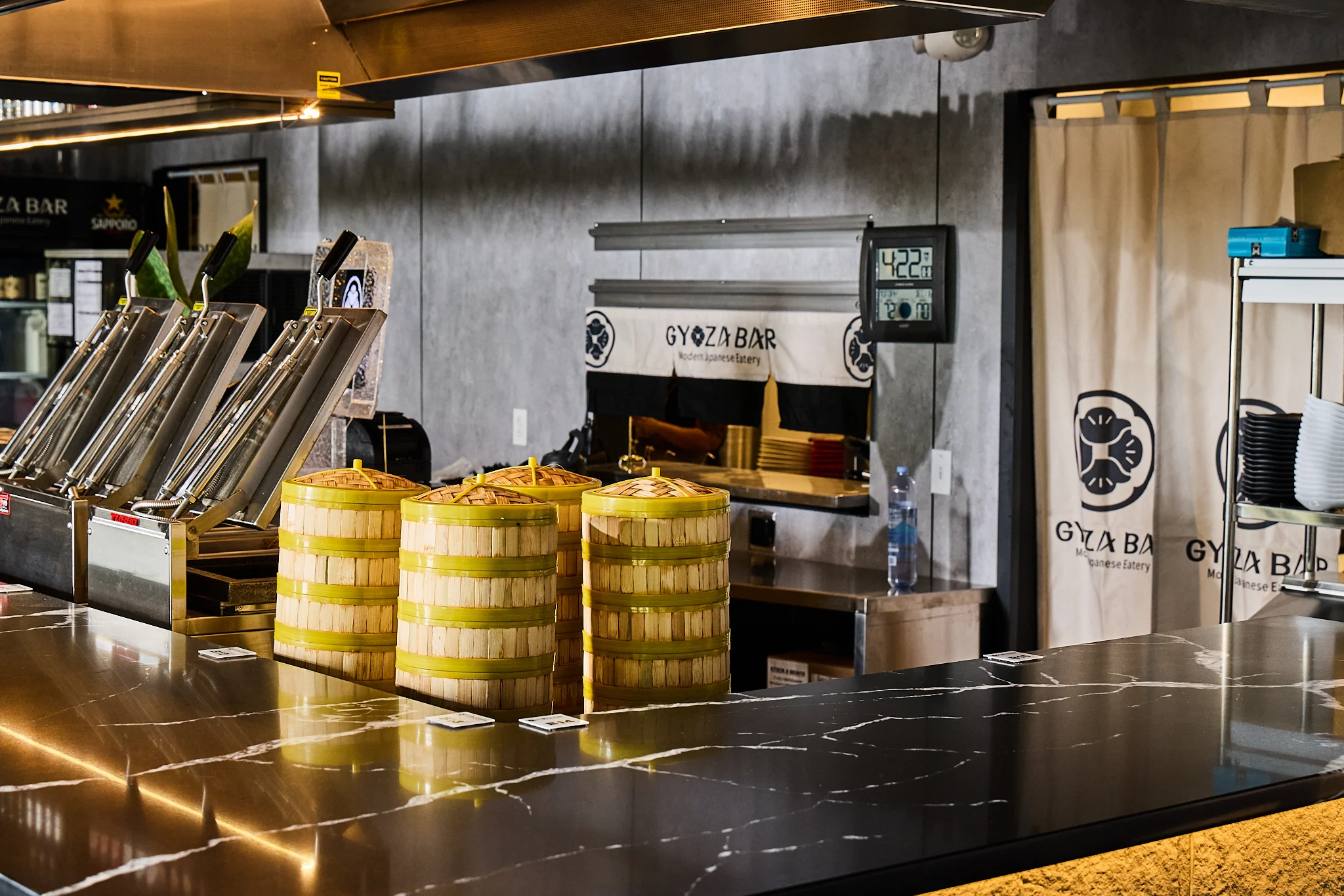Modern Japanese eatery interior with gyoza steamers