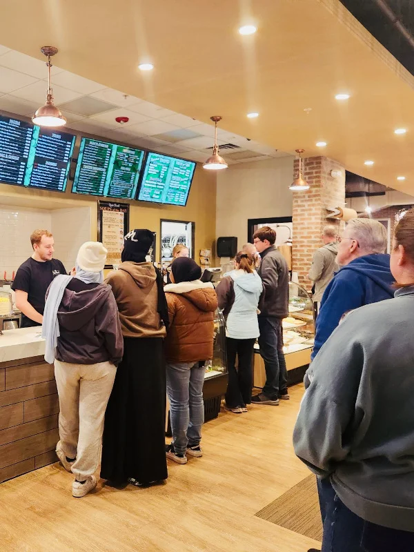 Busy restaurant interior with customers at the counter