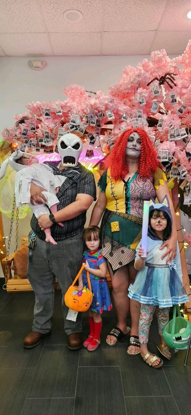 Family in costumes at ShakeiT Boba’s 2025 Halloween celebration