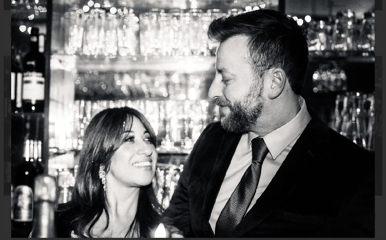 Bartender and guest sharing a moment at a stylish bar