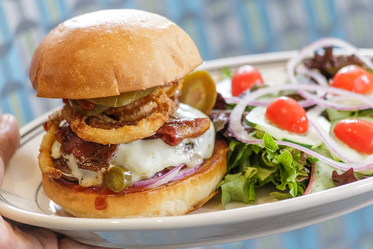 Juicy American cheeseburger with crispy onion rings