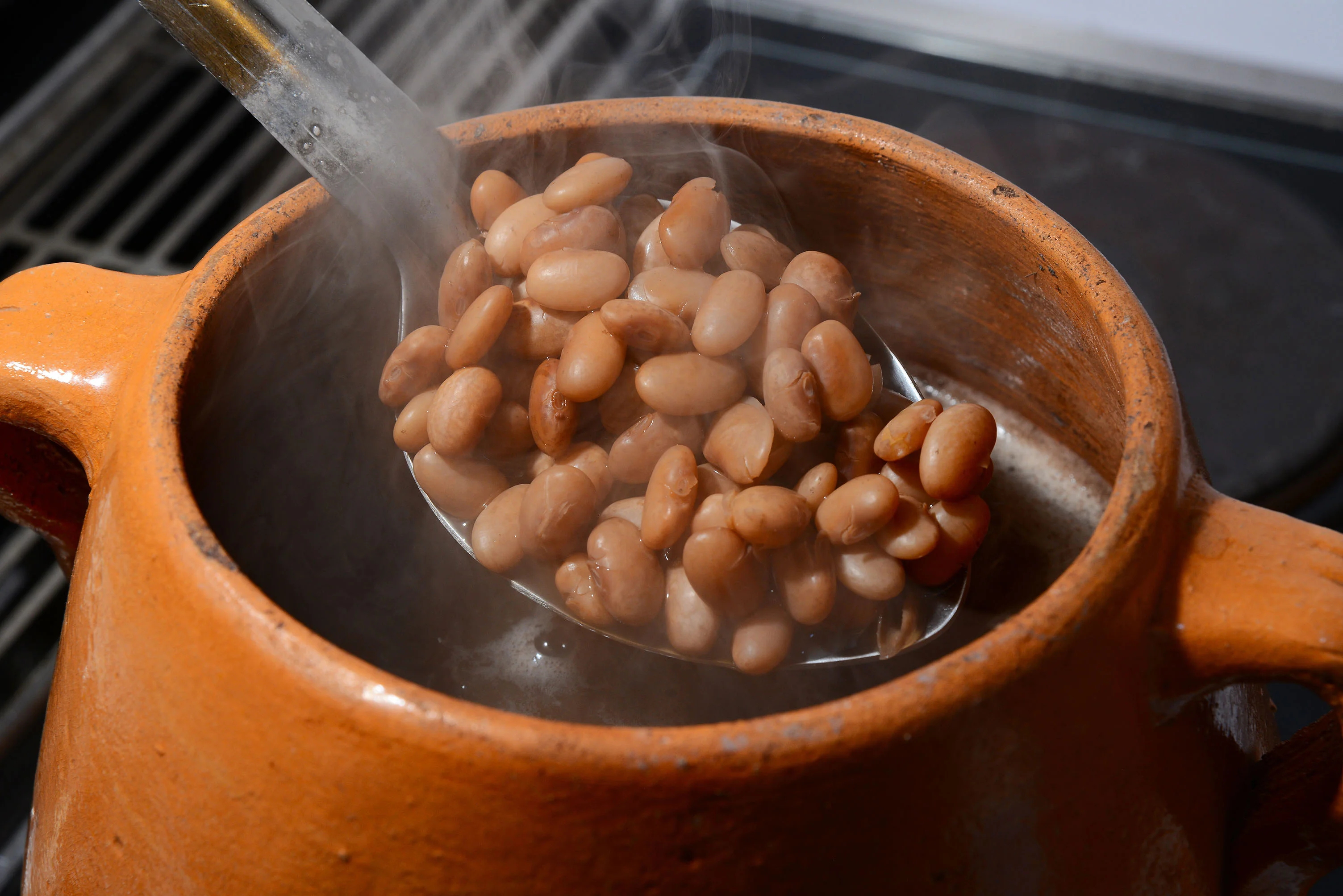 Steaming pot of traditional Mexican frijoles