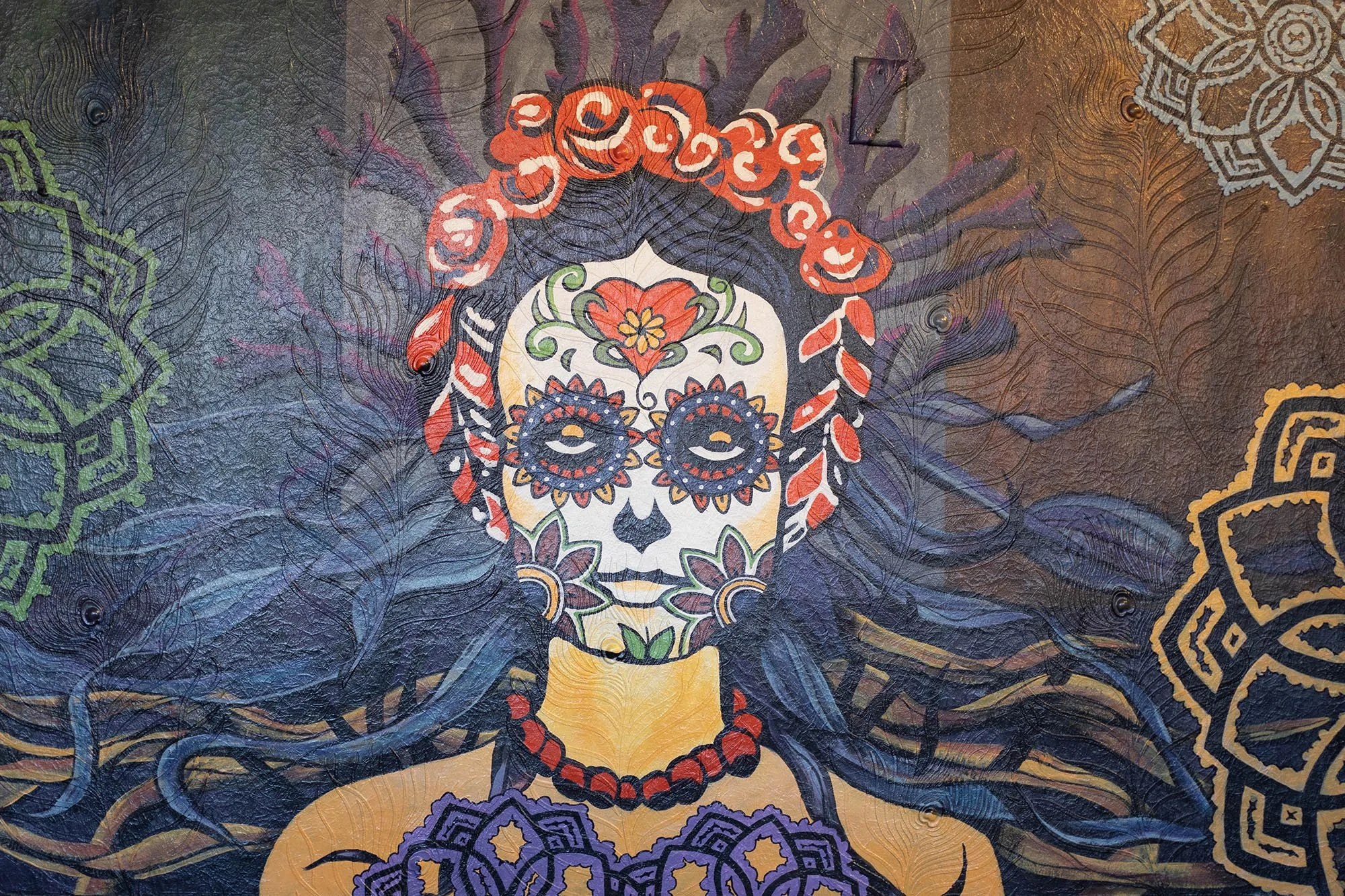 Colorful mural of a sugar skull with floral designs