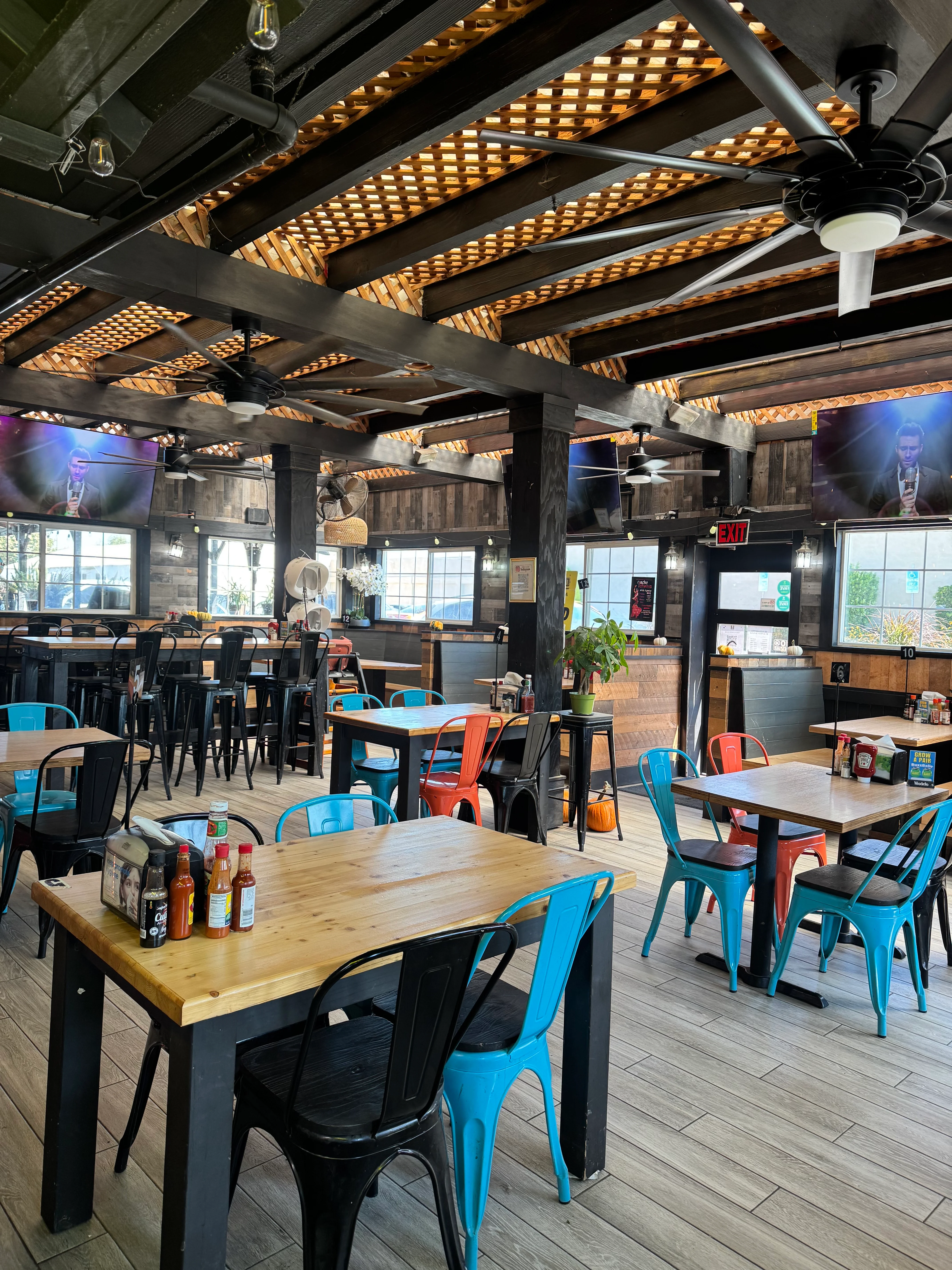 Cozy restaurant interior with colorful chairs and wooden tables