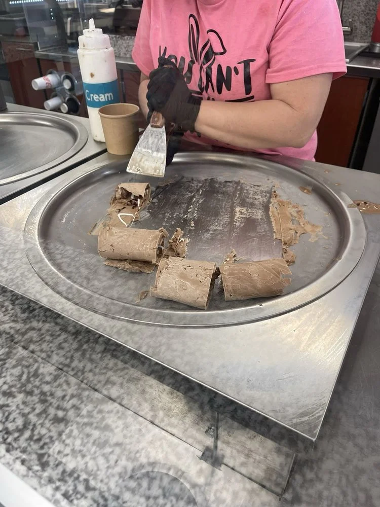 Thai rolled ice cream being prepared on a cold plate