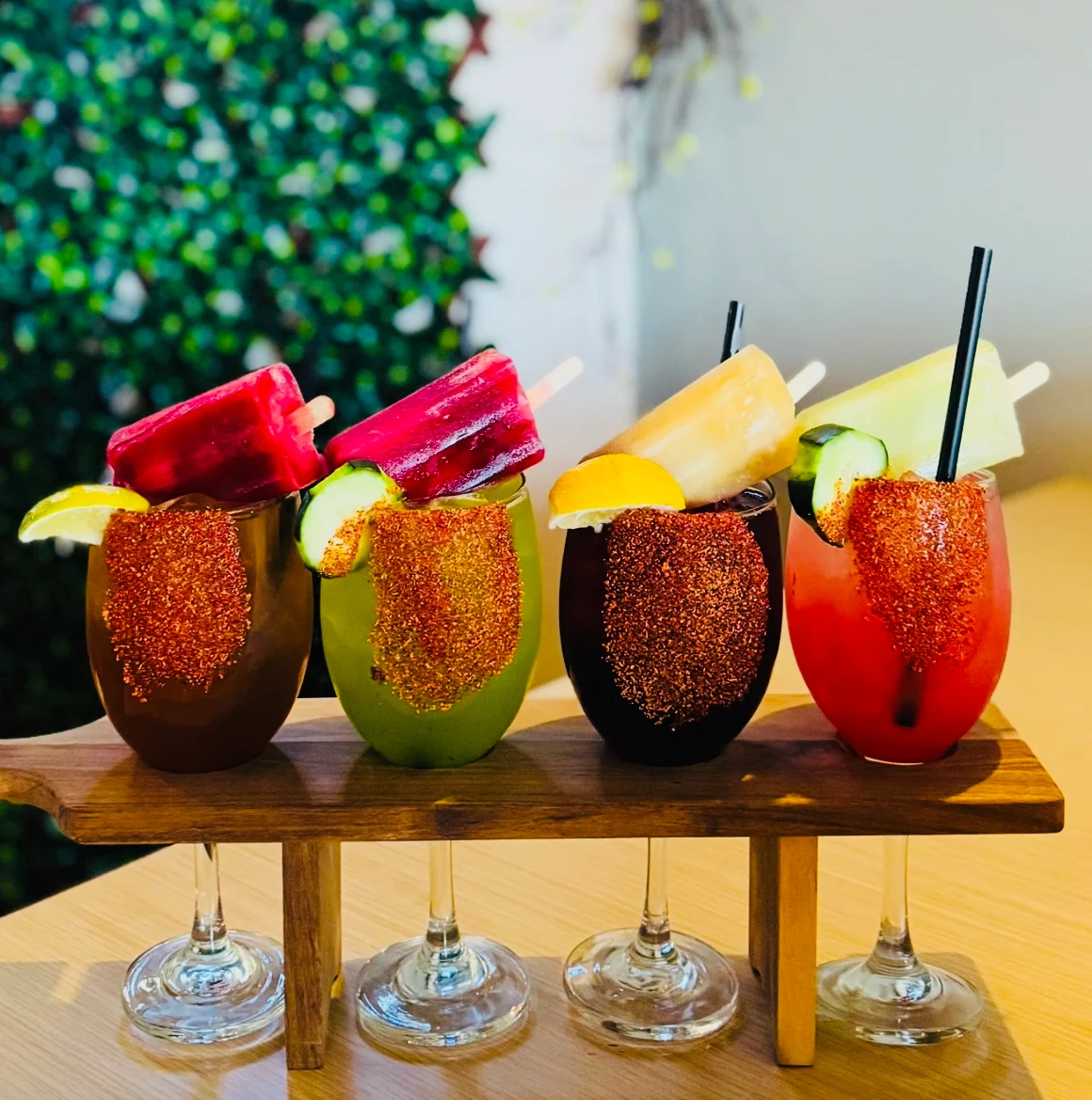 Colorful Mexican cocktails with popsicles and garnishes