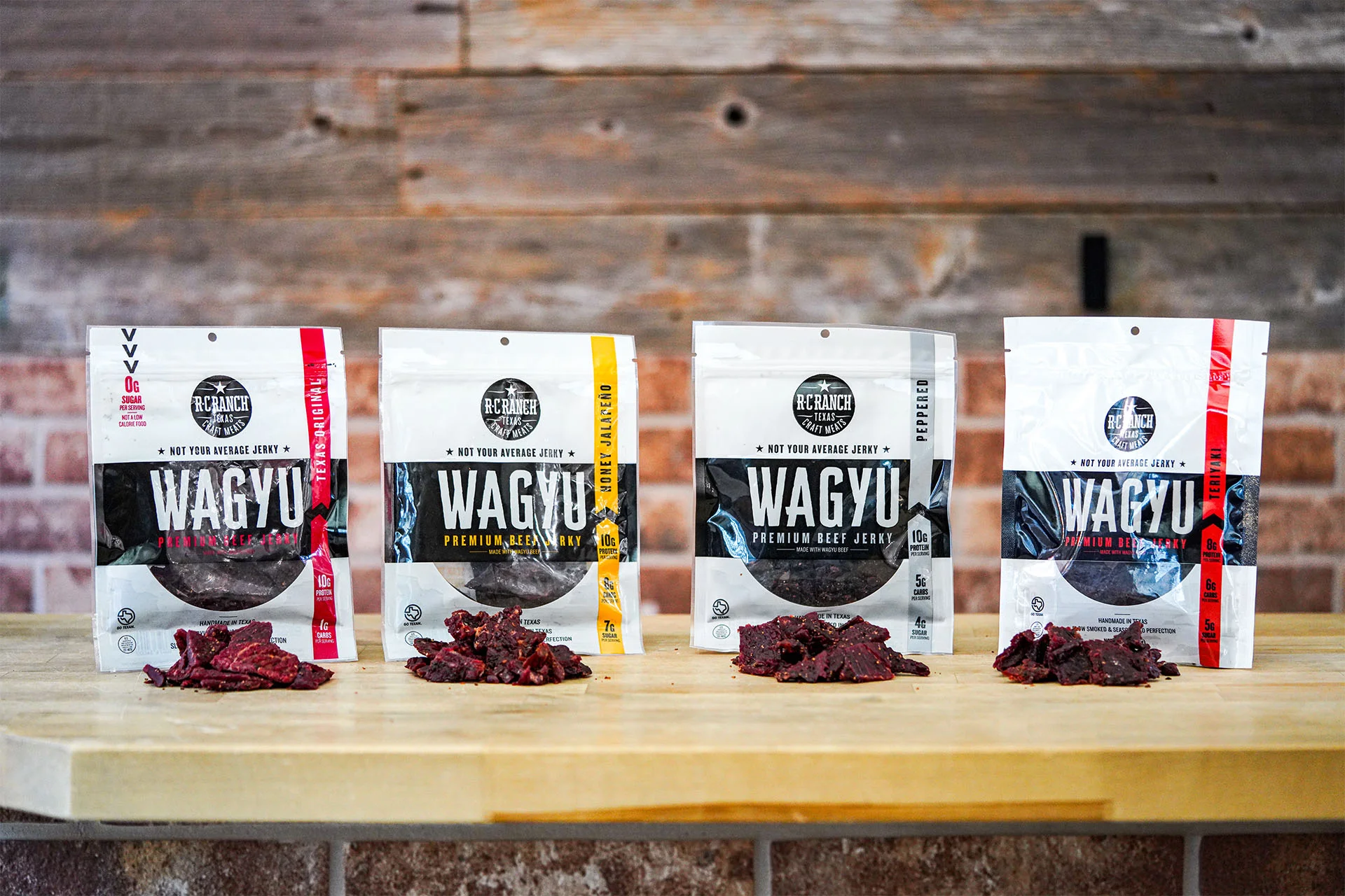 Variety of Wagyu beef jerky packages on a wooden table