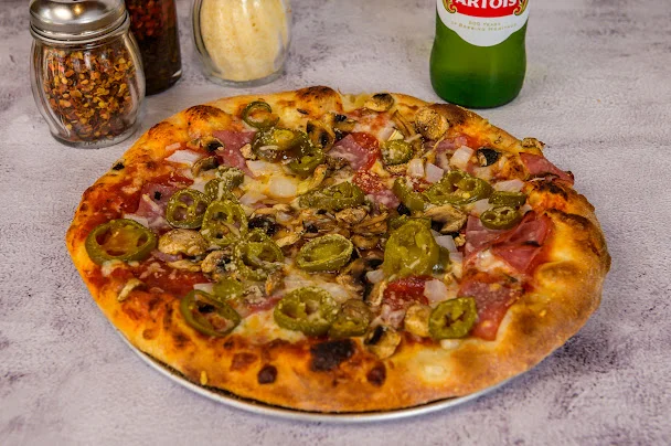 Delicious pepperoni pizza with jalapeños and mushrooms