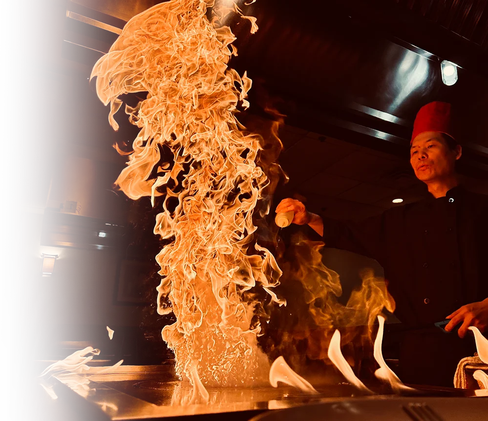  Hibachi chef lighting a tall flame tower at a teppanyaki table at Mahzu East Windsor