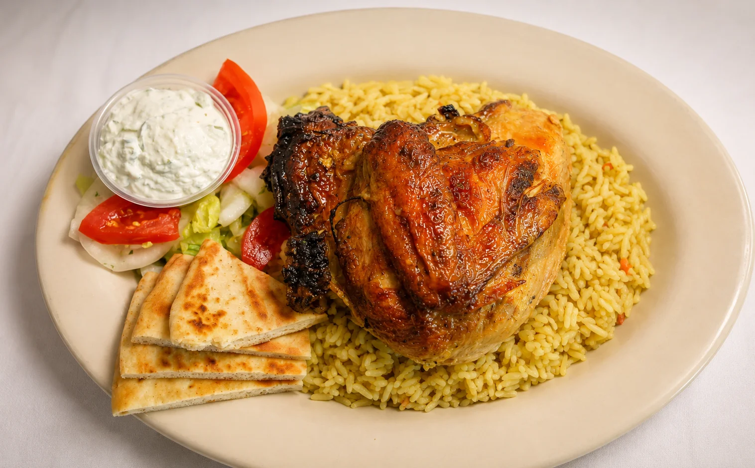 Grilled Mediterranean chicken with rice and salad on a plate