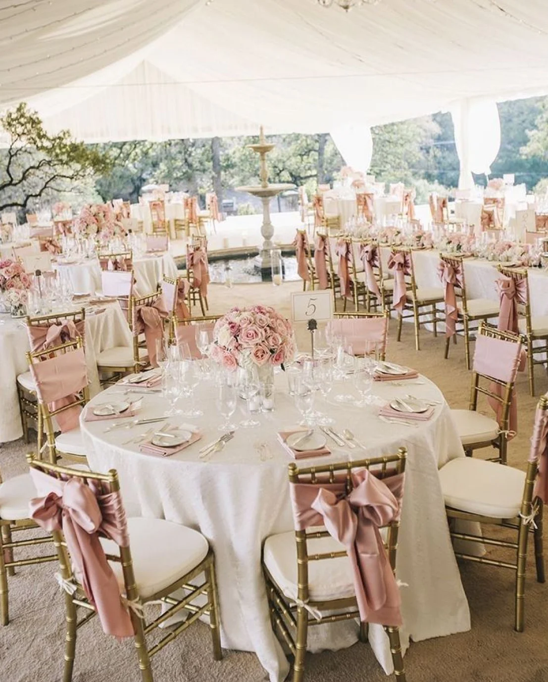 Elegant wedding reception setup with pink decor and floral centerpieces