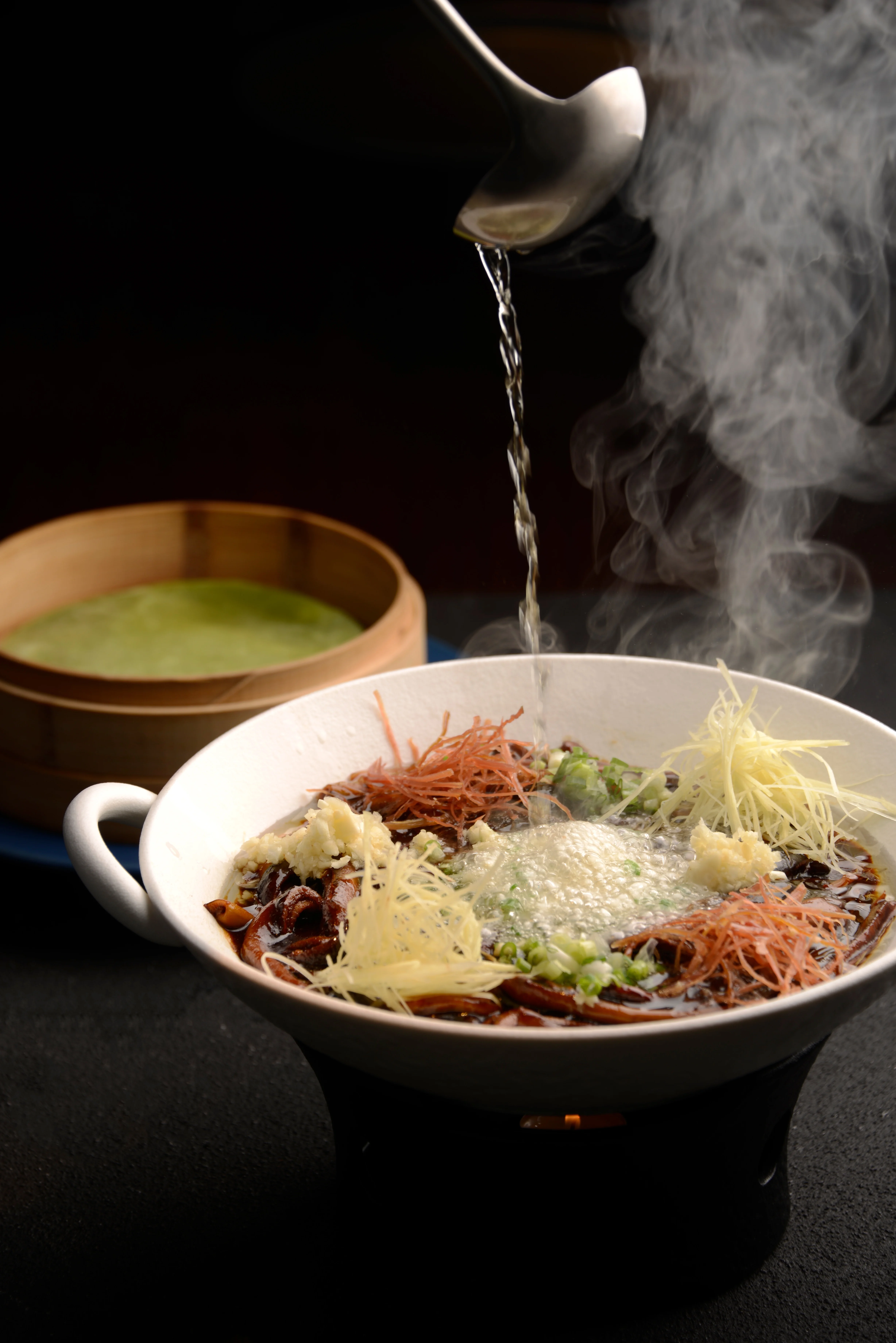 Sichuan hot pot with steaming broth and garnishes