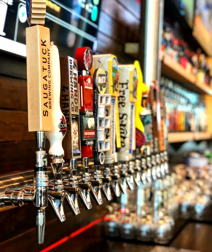 Craft beer taps lined up at a modern bar