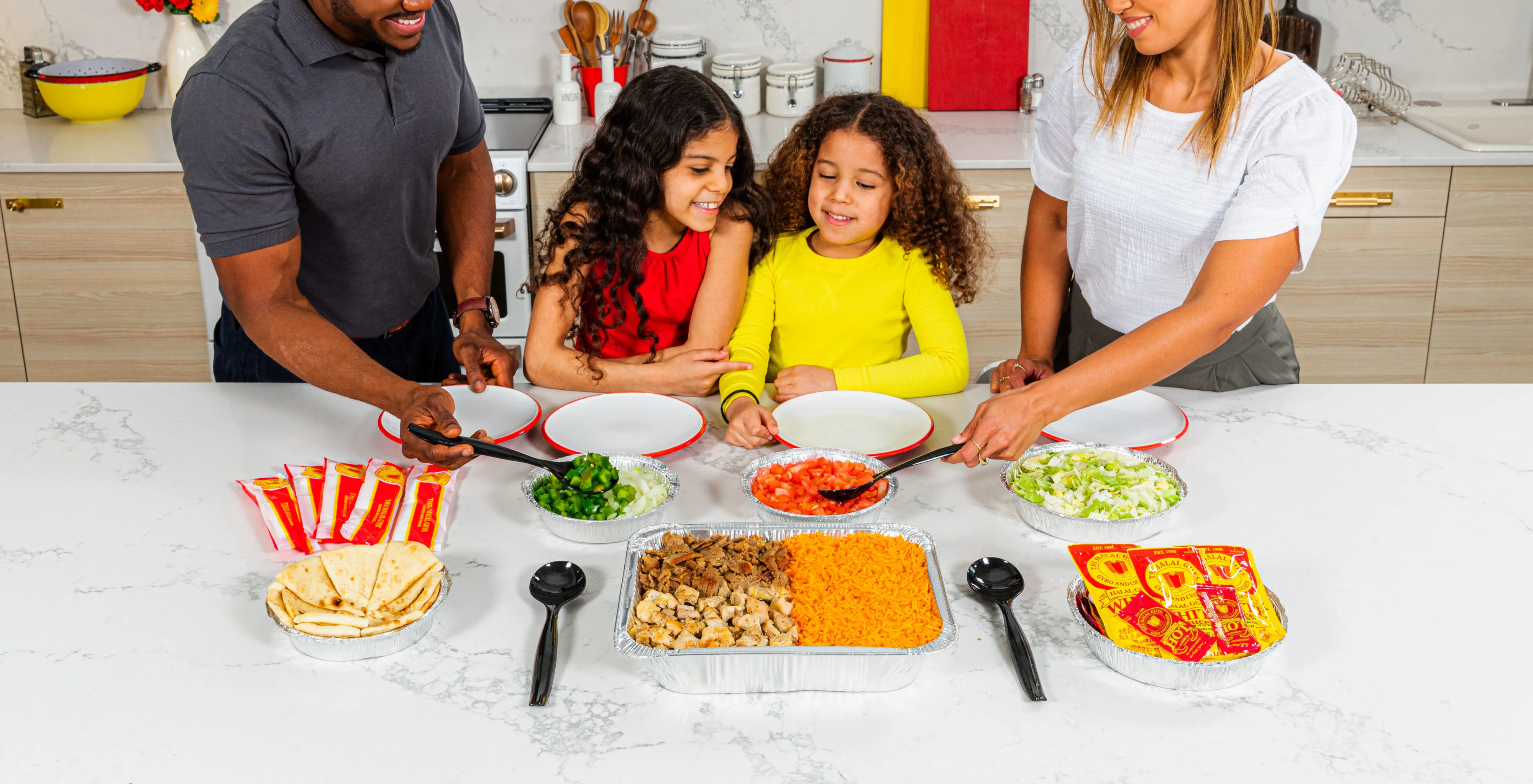 A family enjoying a spread of Yalla Yummies