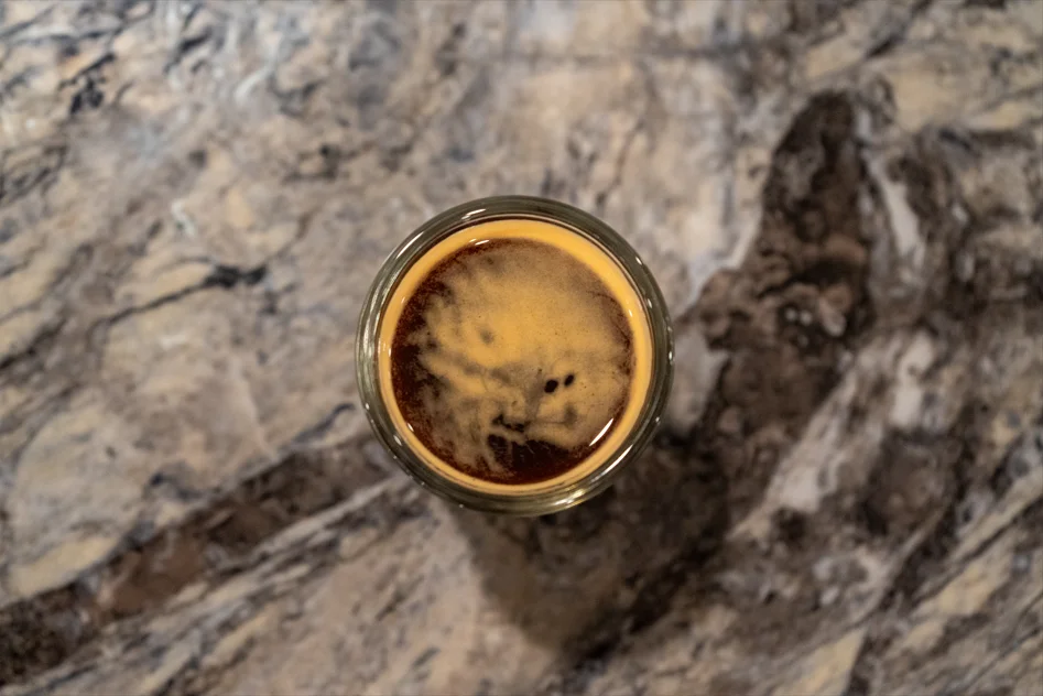 Close-up of espresso with rich crema on a marble surface