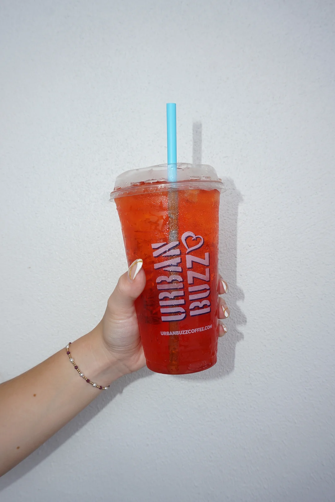 Refreshing iced tea in a clear cup from Urban Buzz Coffee