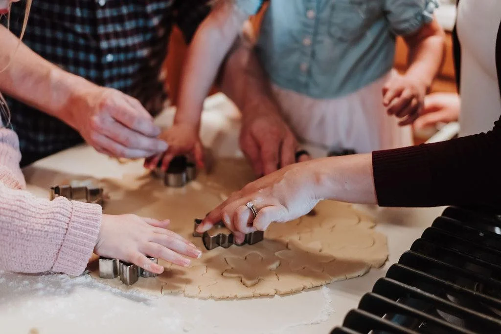 Family baking cookies together in a cozy kitchen
