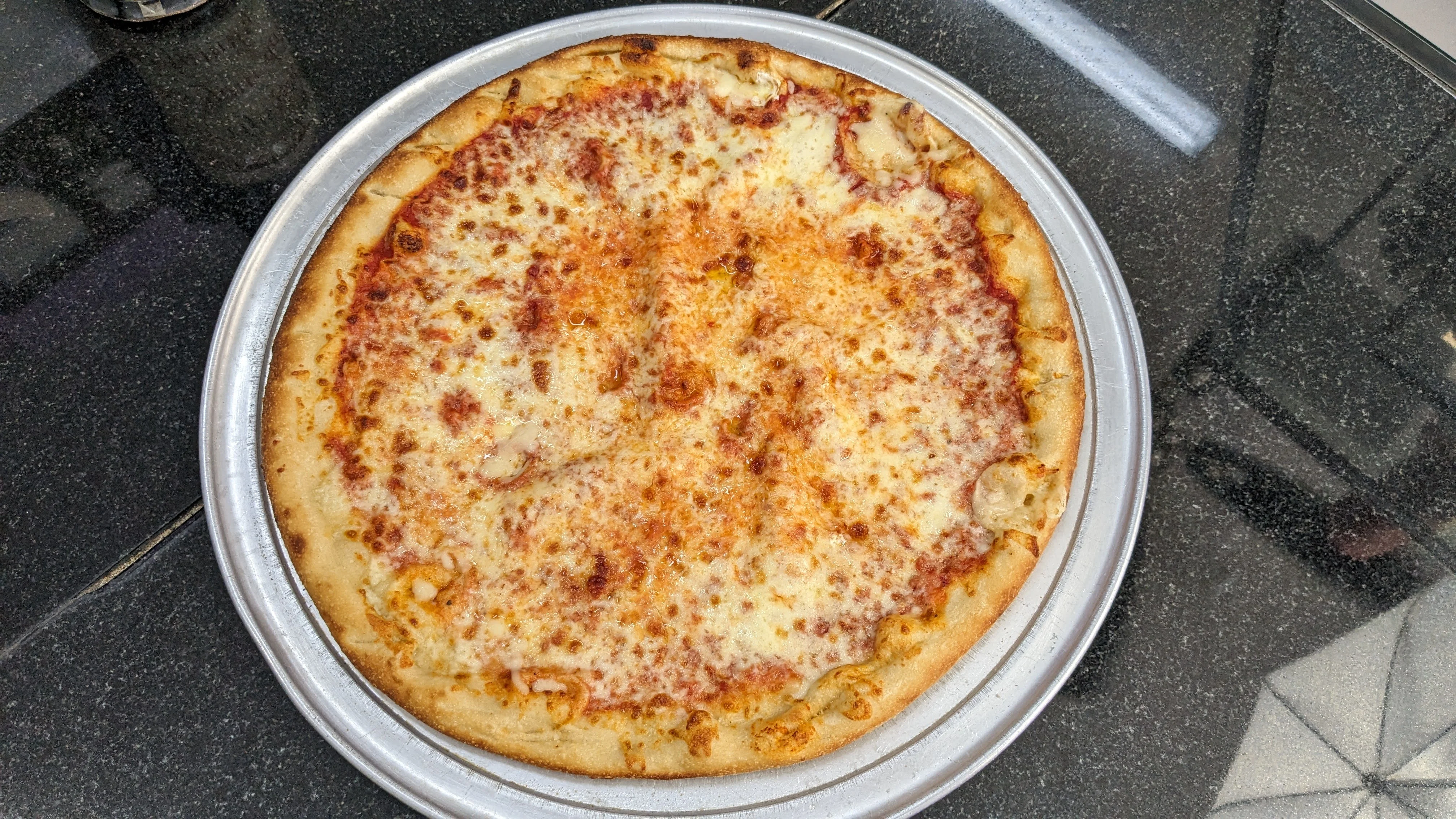 Cheese pizza on a silver platter
