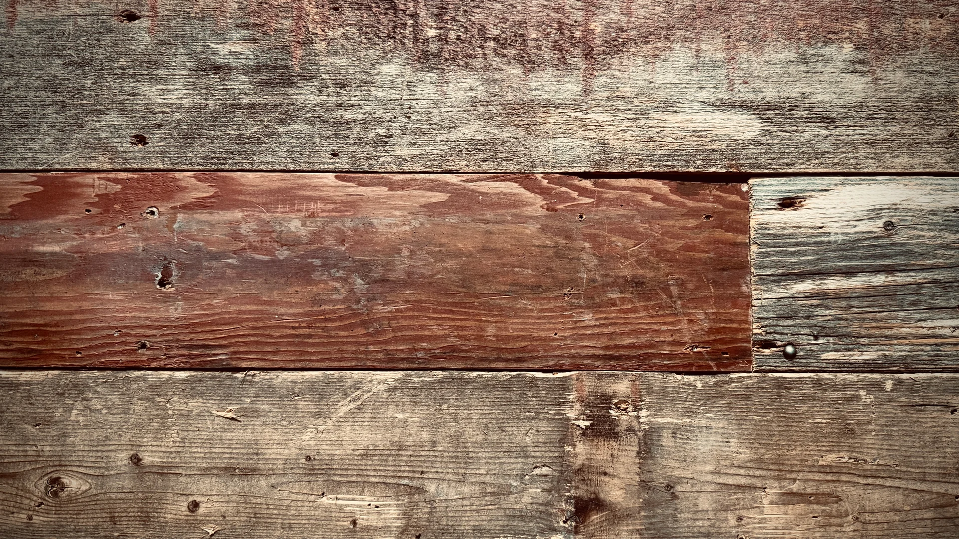 Rustic wooden wall with varied textures and colors