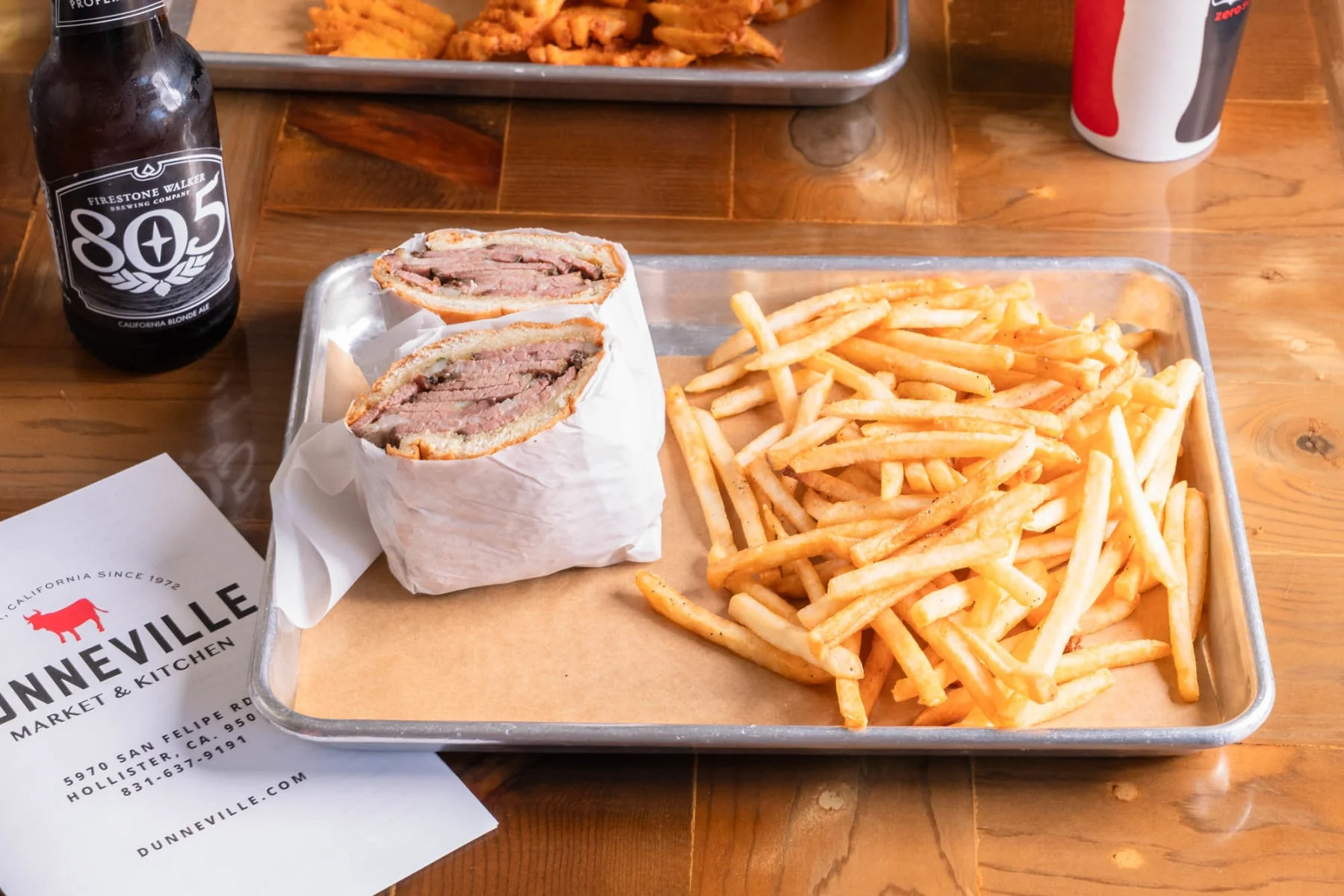 Delicious prime rib sandwich served with fresh toppings and a side of fries.