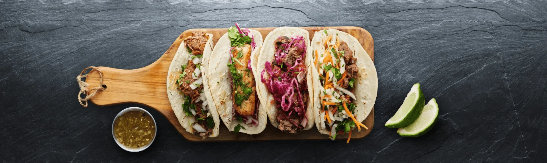 Assorted Mexican tacos on a wooden board