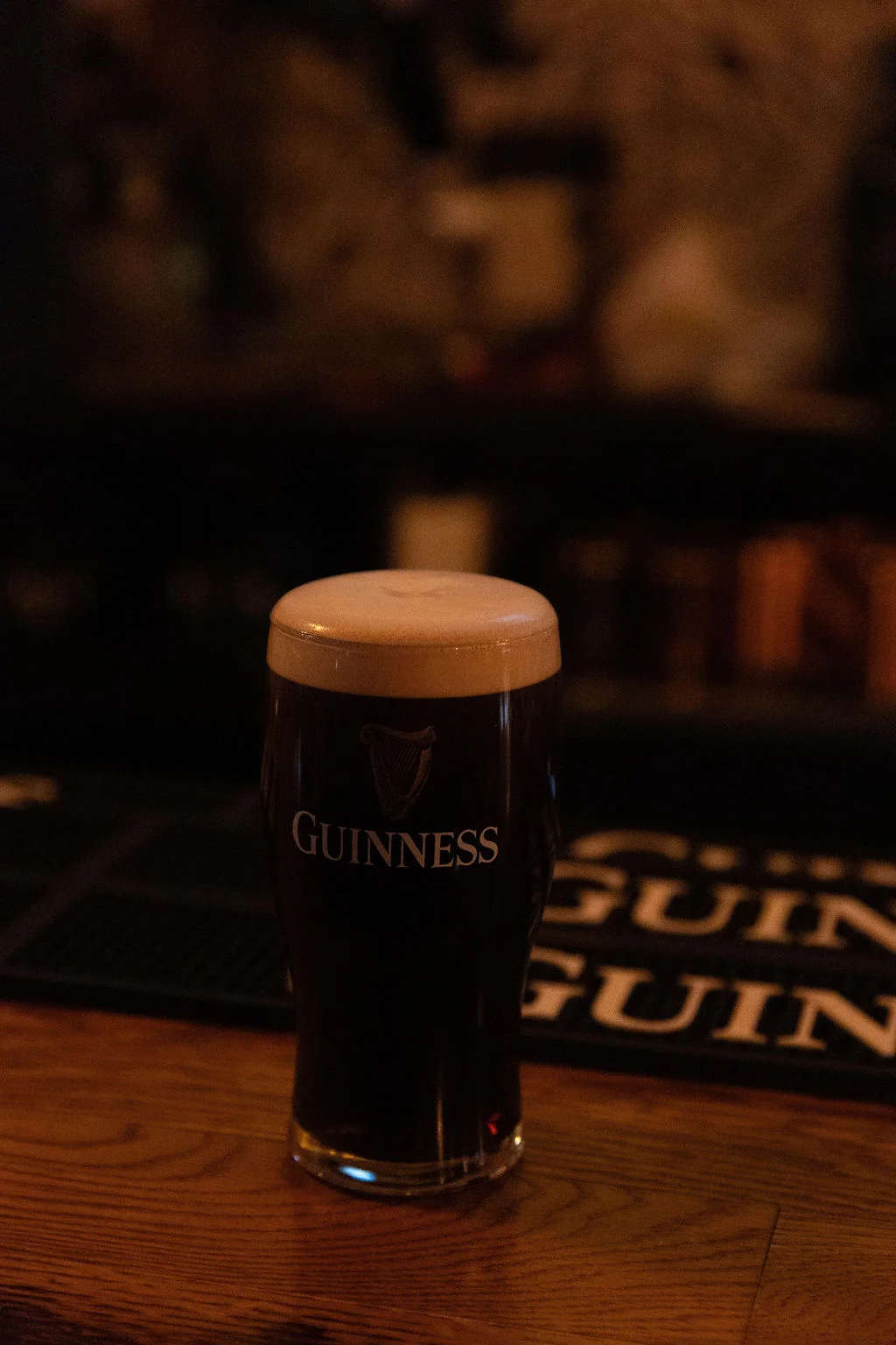 Pint of Guinness beer on a bar counter