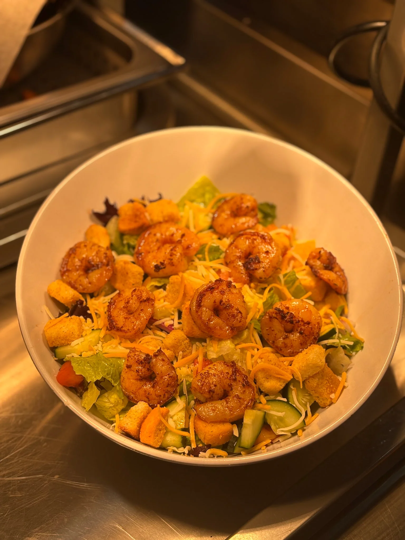 Spicy shrimp salad with mixed greens and crunchy toppings