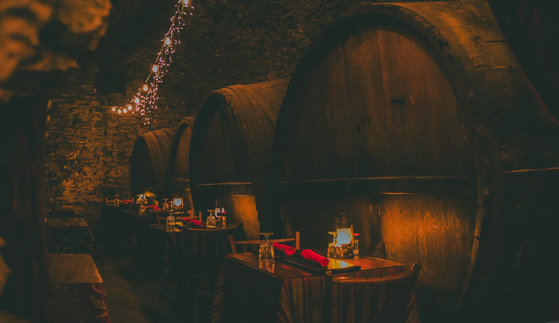 Cozy restaurant interior with stone walls and candlelit tables