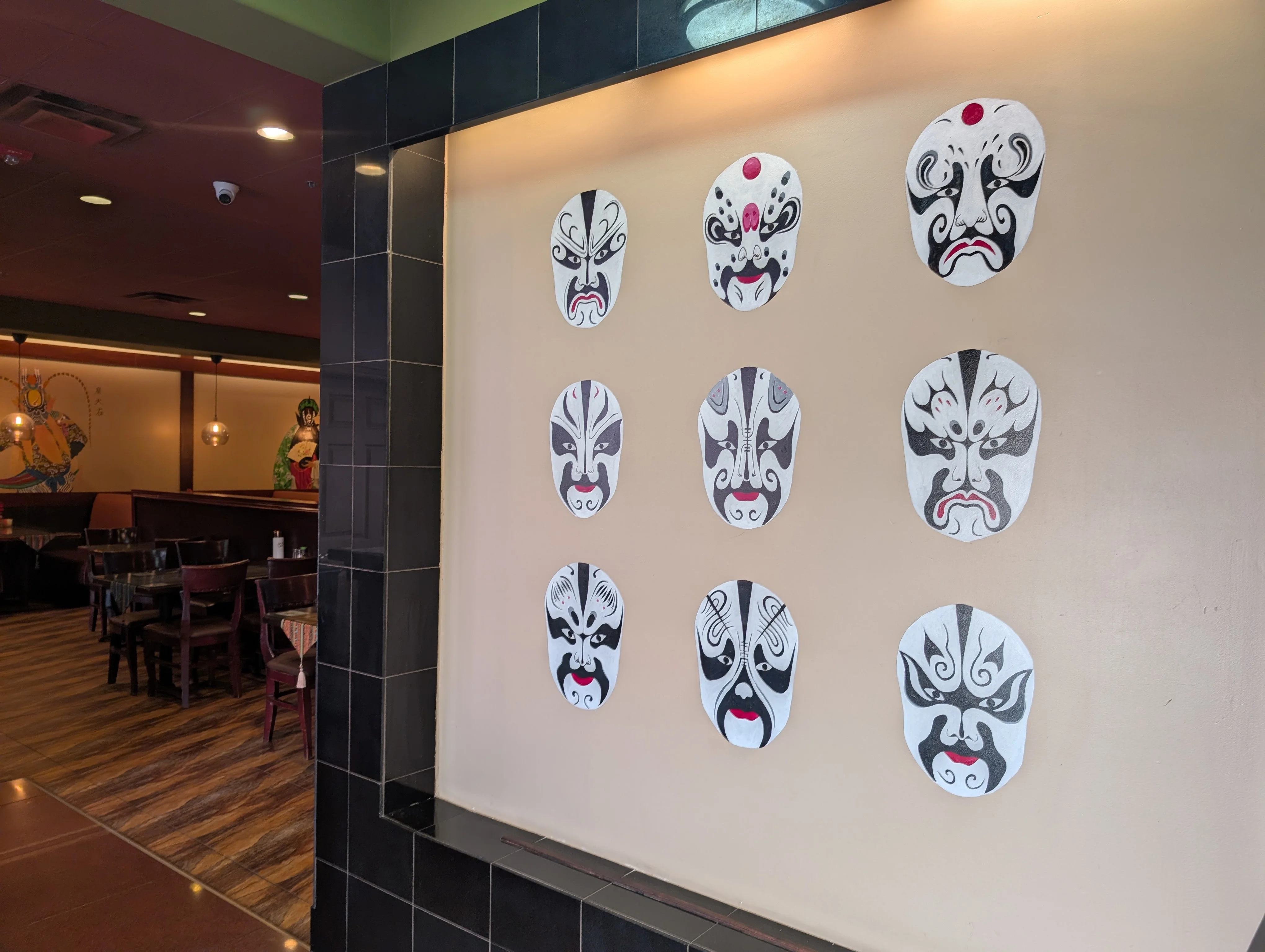 Decorative Chinese opera masks on restaurant wall