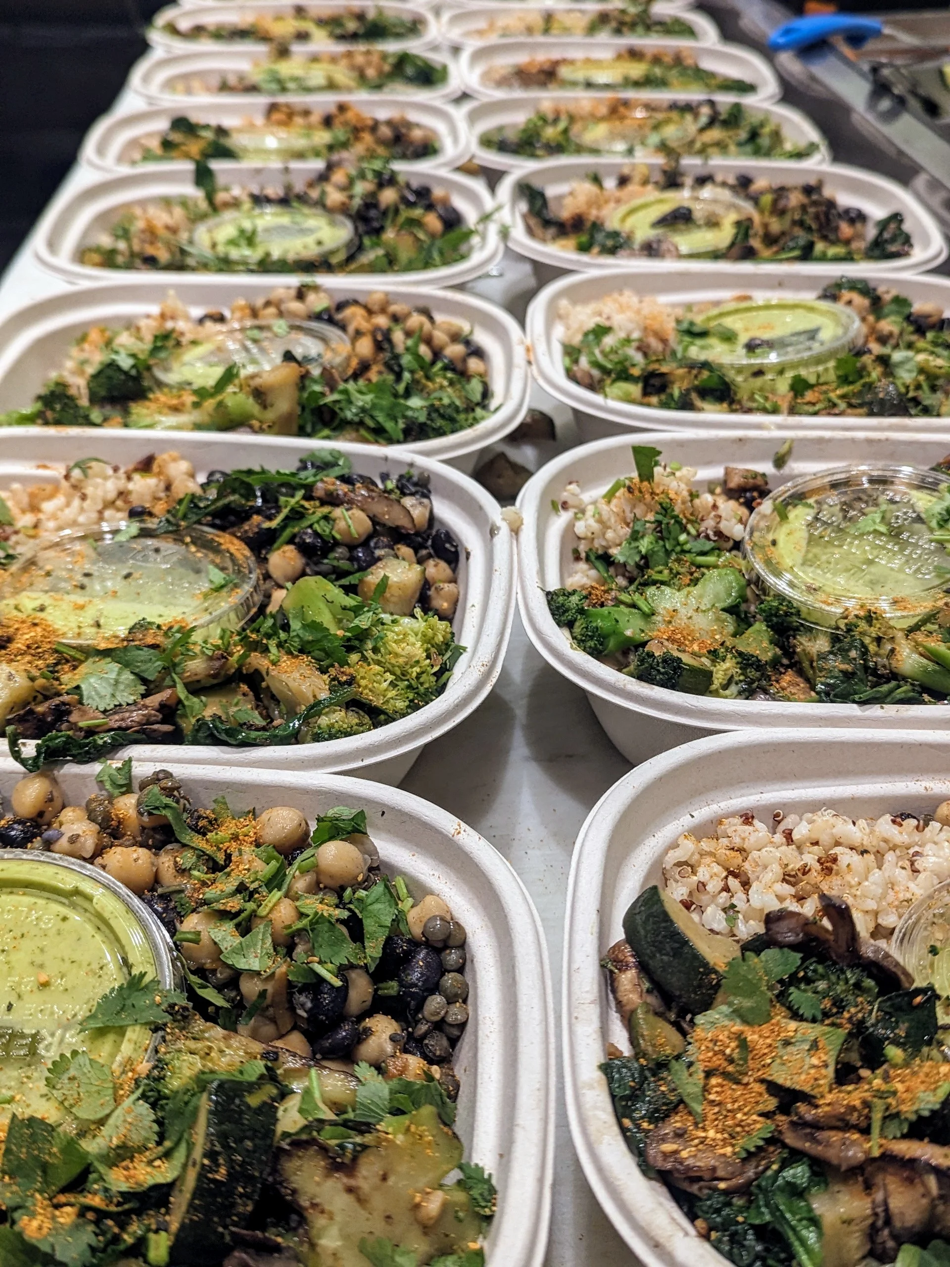 Vegan grain bowl with mixed vegetables and green sauce