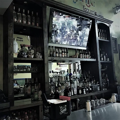Well-stocked bar with a TV and decorative elements