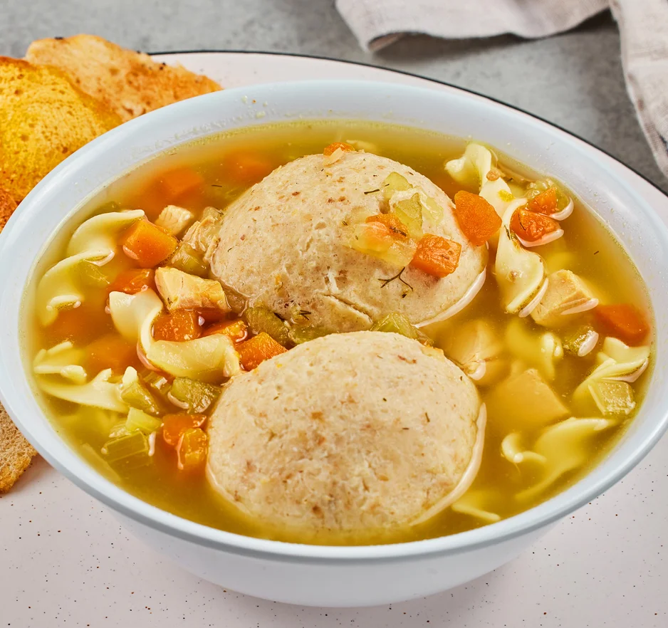 Chicken matzoh ball soup with noodles and vegetables