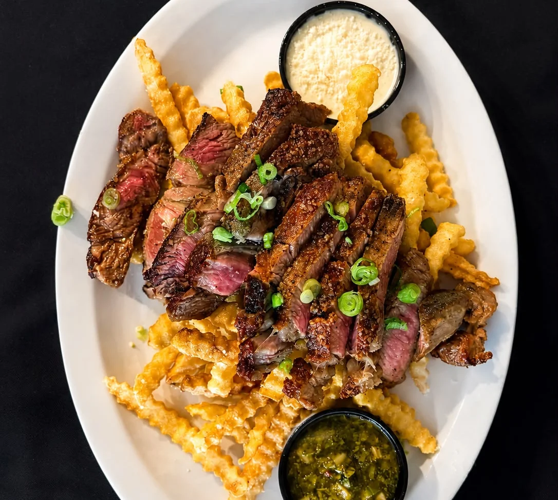 Grilled steak frites served with dipping sauces