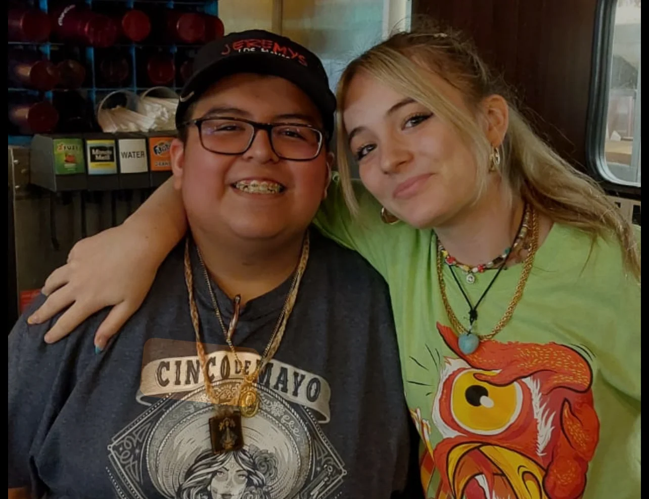 Two smiling restaurant staff members posing together