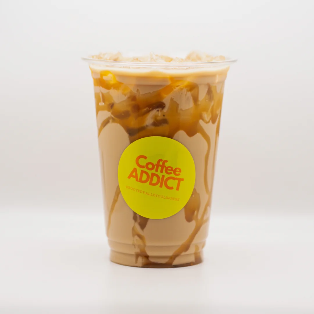 Iced coffee drink with caramel drizzle in a clear cup