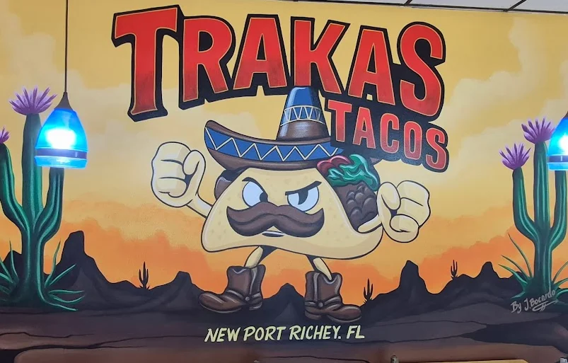 Colorful mural of a taco character at Trakas Tacos restaurant
