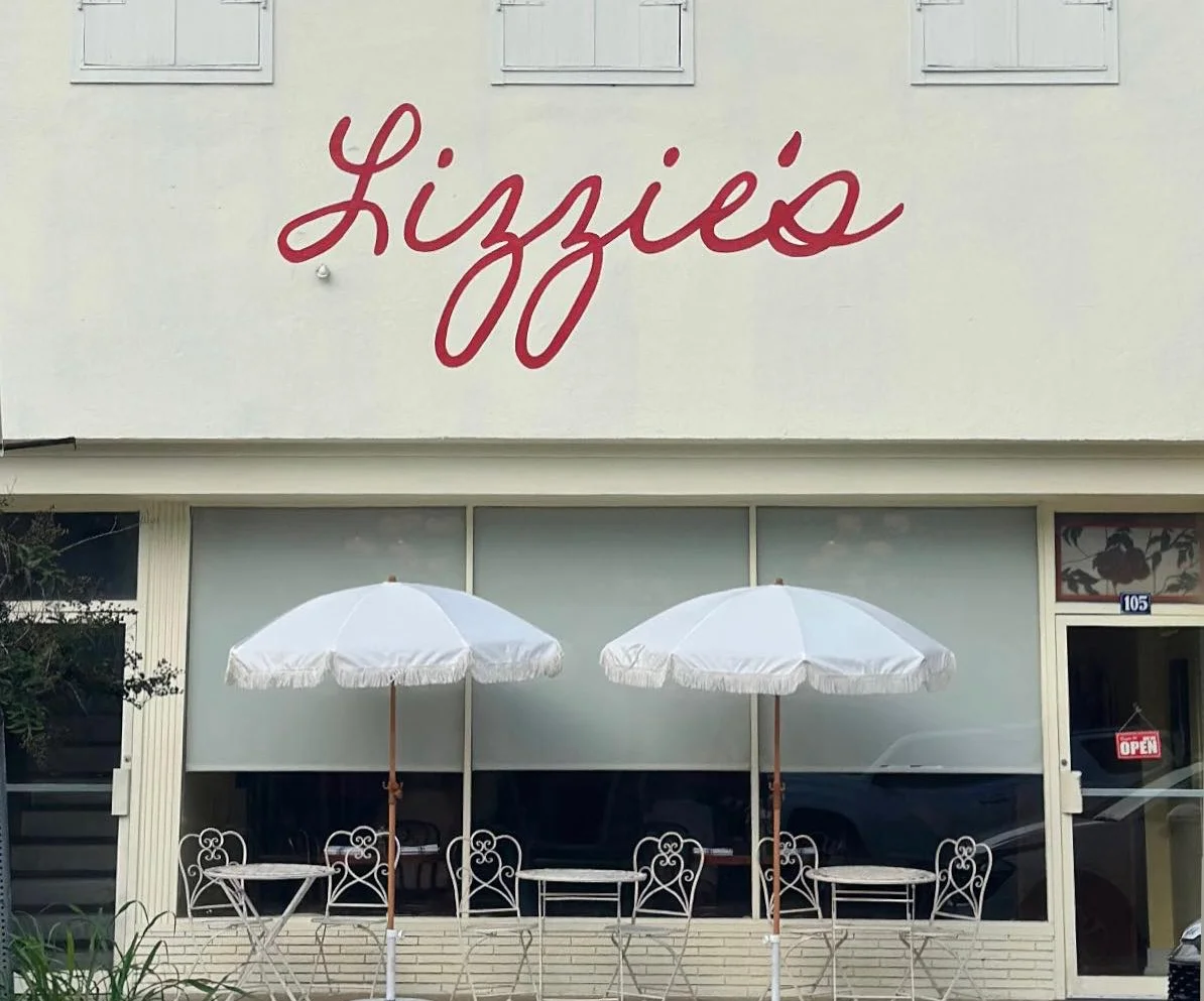 Charming restaurant exterior with white umbrellas and vintage decor