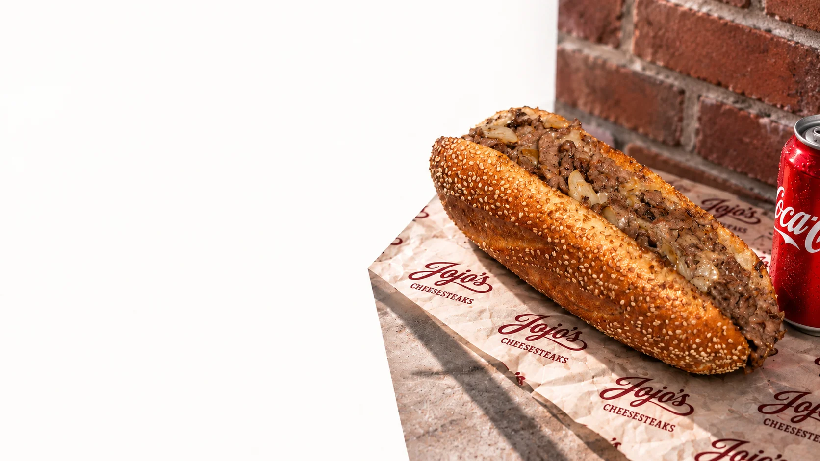 Delicious cheesesteak sandwich with sautéed onions on a sesame seed hoagie roll