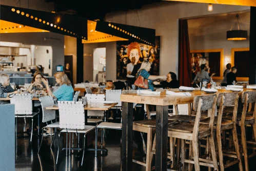 Modern restaurant interior with wooden seating and vibrant decor