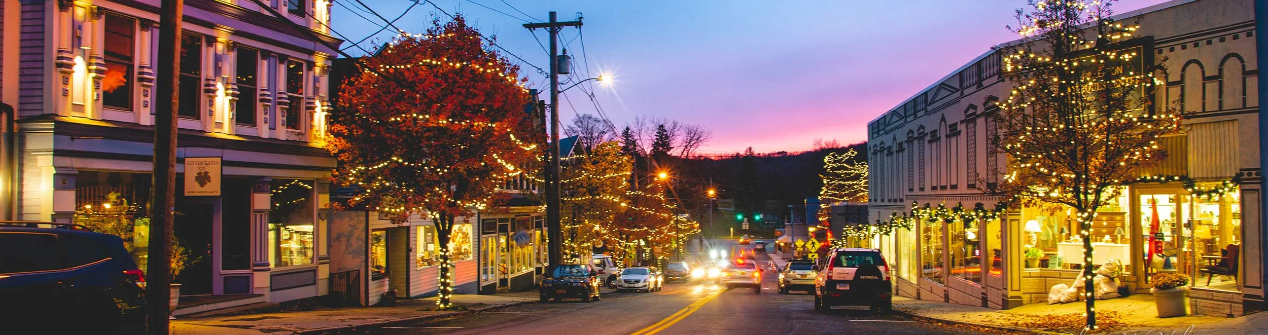 Charming street decorated with holiday lights at dusk