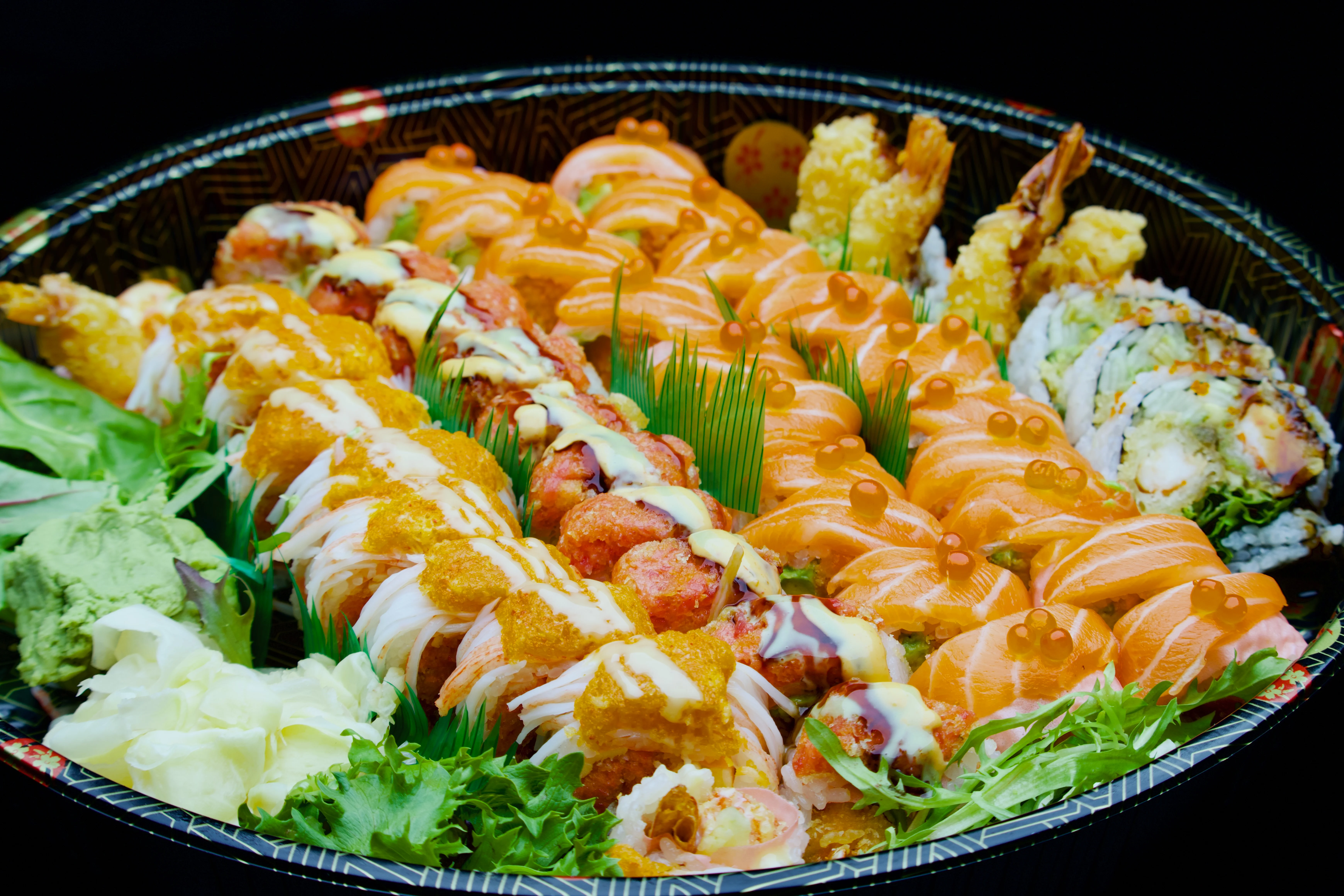 A beautifully arranged platter of assorted sushi and sashimi.