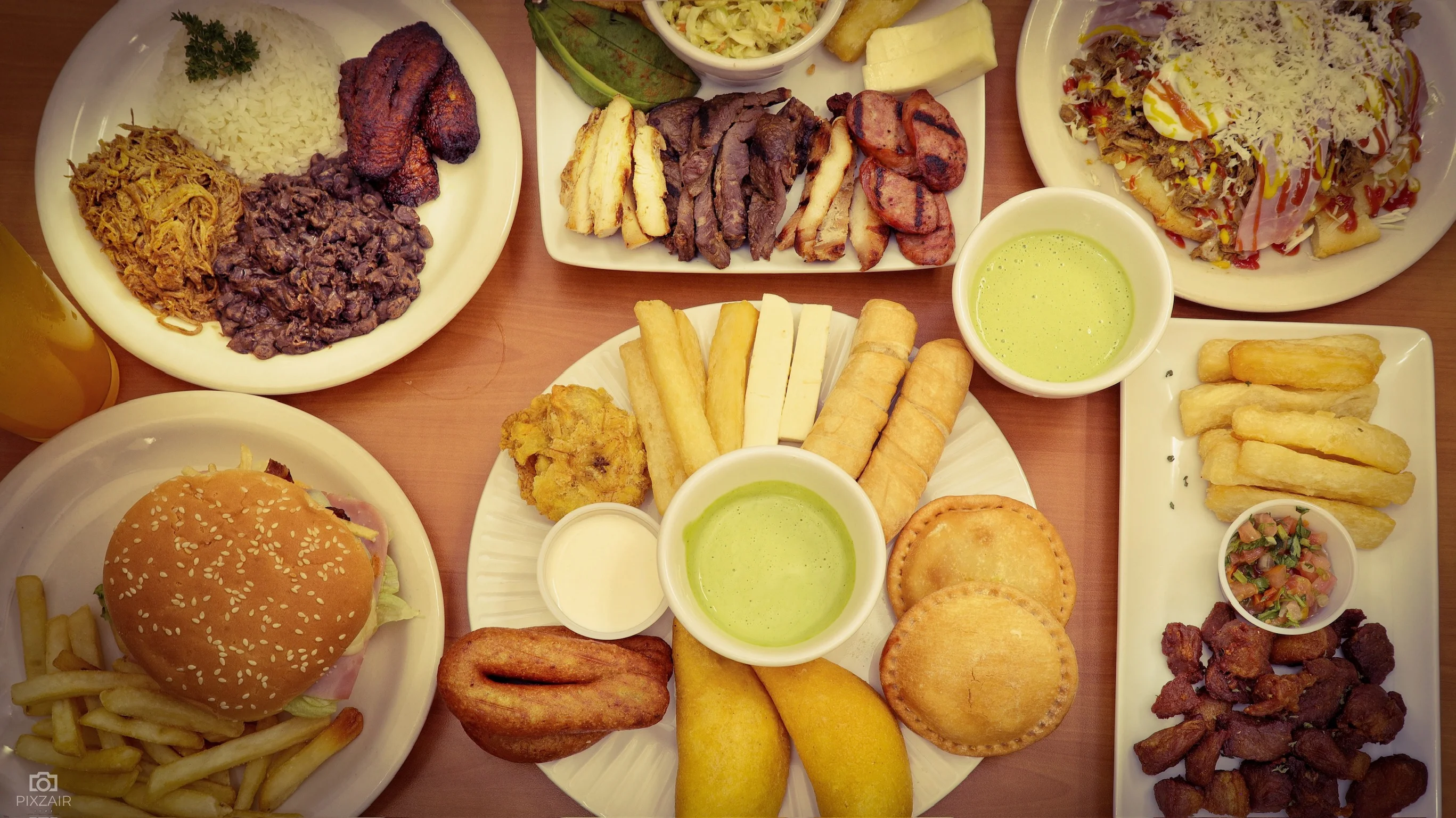 Assorted Latin American dishes including arepas and fried plantains