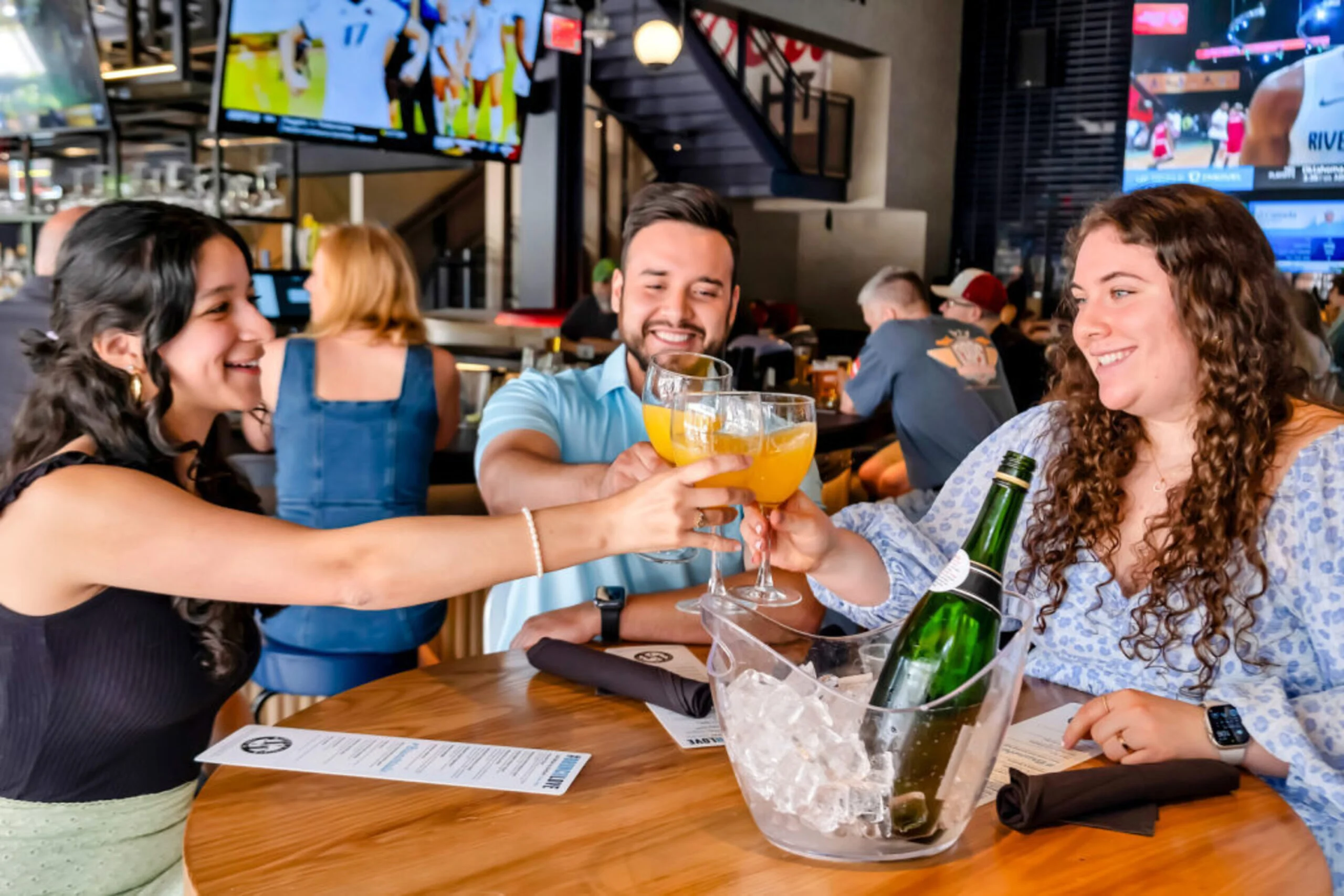 A vibrant sports bar with large screens and a lively atmosphere.