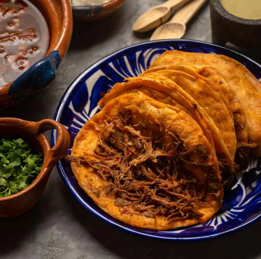 Mexican tlayudas topped with shredded meat